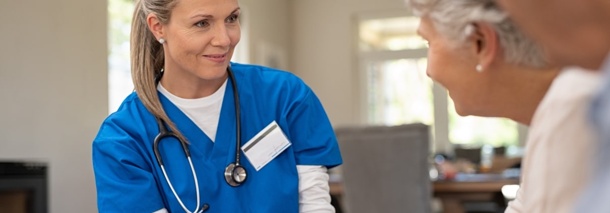 Senior nurse speaking with patients